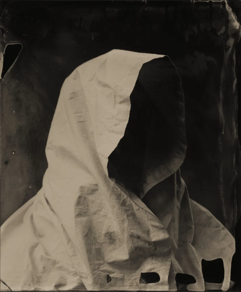 This image depicts a photograph by artist Ben Cauchi titled 'Guardian (after Sassoferrato)', an artwork made in 2006. The medium is ambrotype. The size of this artwork is 43x36 cm. This artwork was first shown in the exhibition 'The Long Horror of that Piteous Night' at Marshall Seifert Gallery in 2006. This artwork is in the collection of the Dunedin Public Art Gallery in Dunedin, New Zealand.